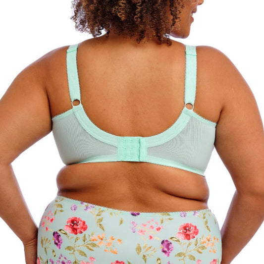 Woman wearing a light blue bikini with floral bottoms on a white background