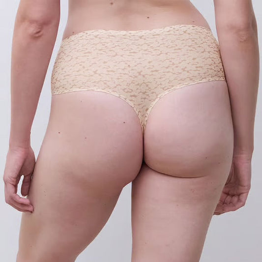Beige lace underwear worn by a person on a plain background