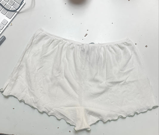 White fabric on a white surface next to a blue fabric