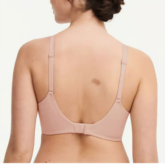 Woman wearing a beige bra on a white background