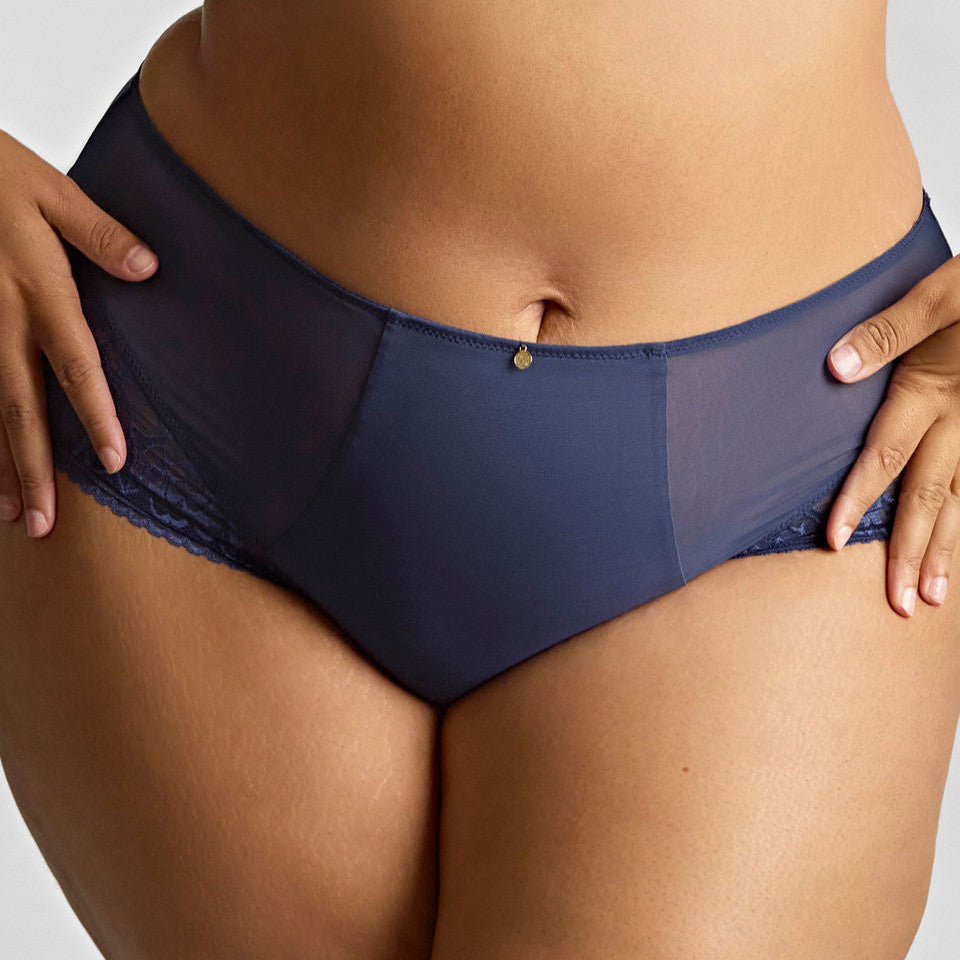 Navy blue underwear worn by a person on a neutral background