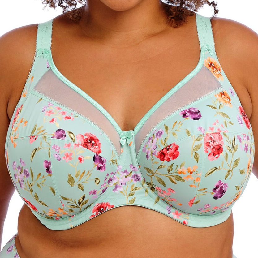 Woman wearing a floral bra and panties set on a white background