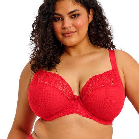 Woman wearing a red bra and underwear set on a white background