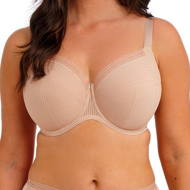 Woman wearing a beige bra and underwear set on a white background