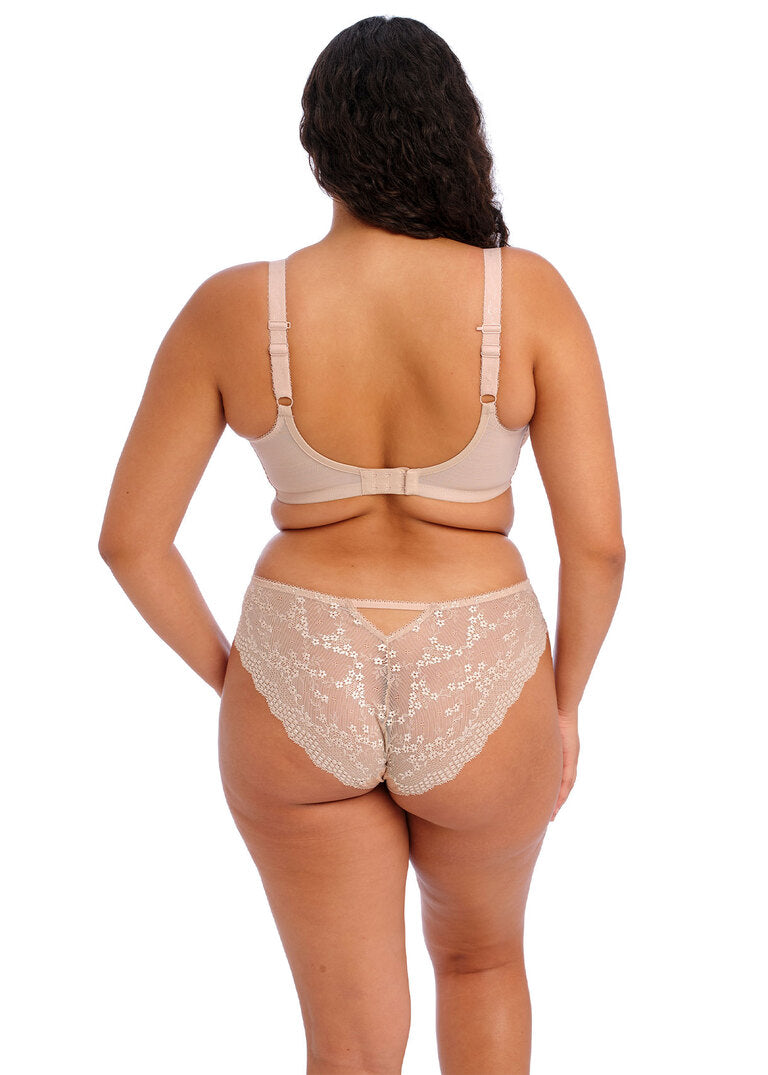 Woman wearing beige lingerie set on a white background