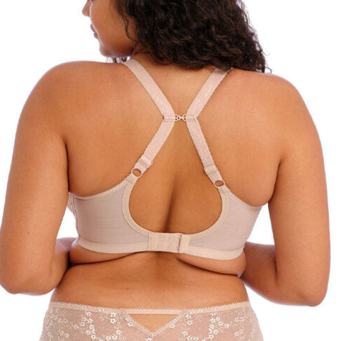 Woman wearing beige lingerie set on a white background