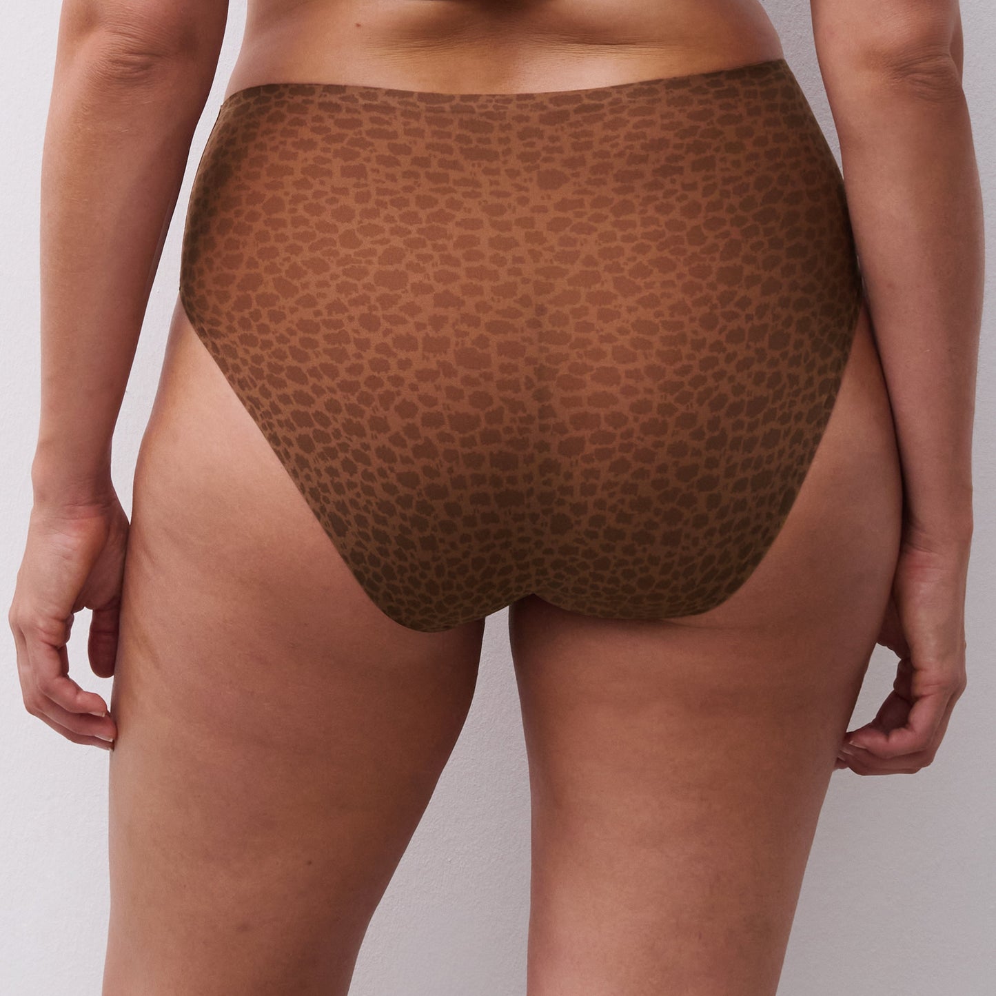 Brown patterned underwear worn by a person on a white background