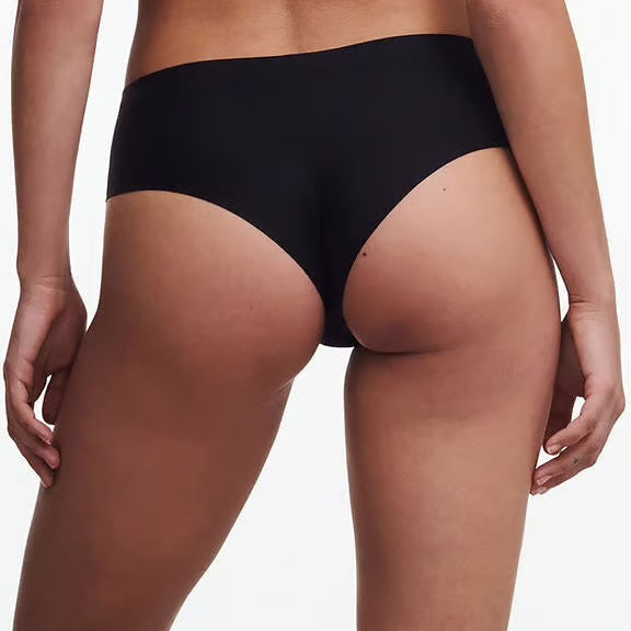 Person wearing black underwear on a plain background