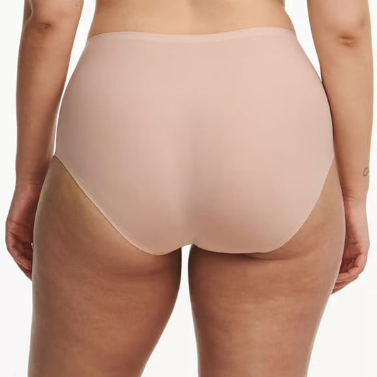 Beige underwear worn by a person on a white background