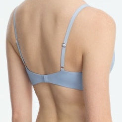 Light blue bra worn by a person on a white background
