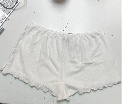 White fabric on a white surface next to a blue fabric