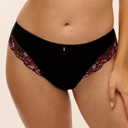 Black lace and mesh panties with pink floral embroidery on the side, shown on a model against a plain beige background.