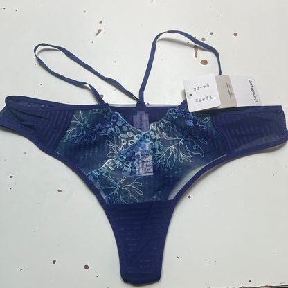 Blue floral-patterned THONG on a white surface with a visible tag.