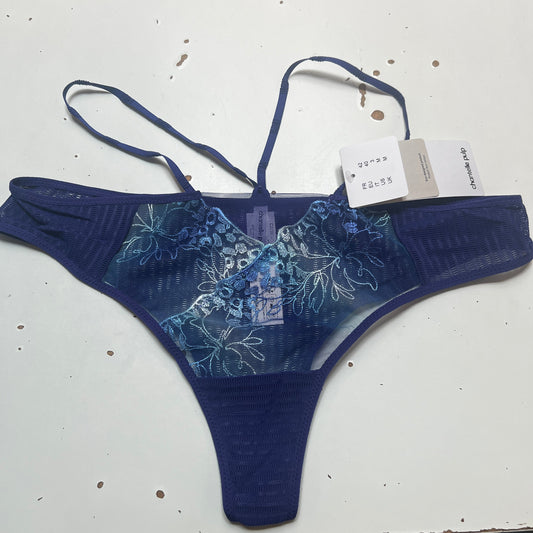 Blue floral-patterned THONG on a white surface with a visible tag.