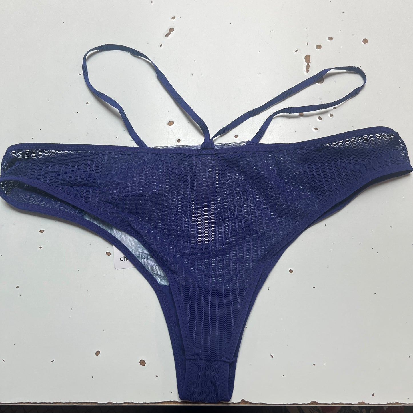 Blue thong on a white surface