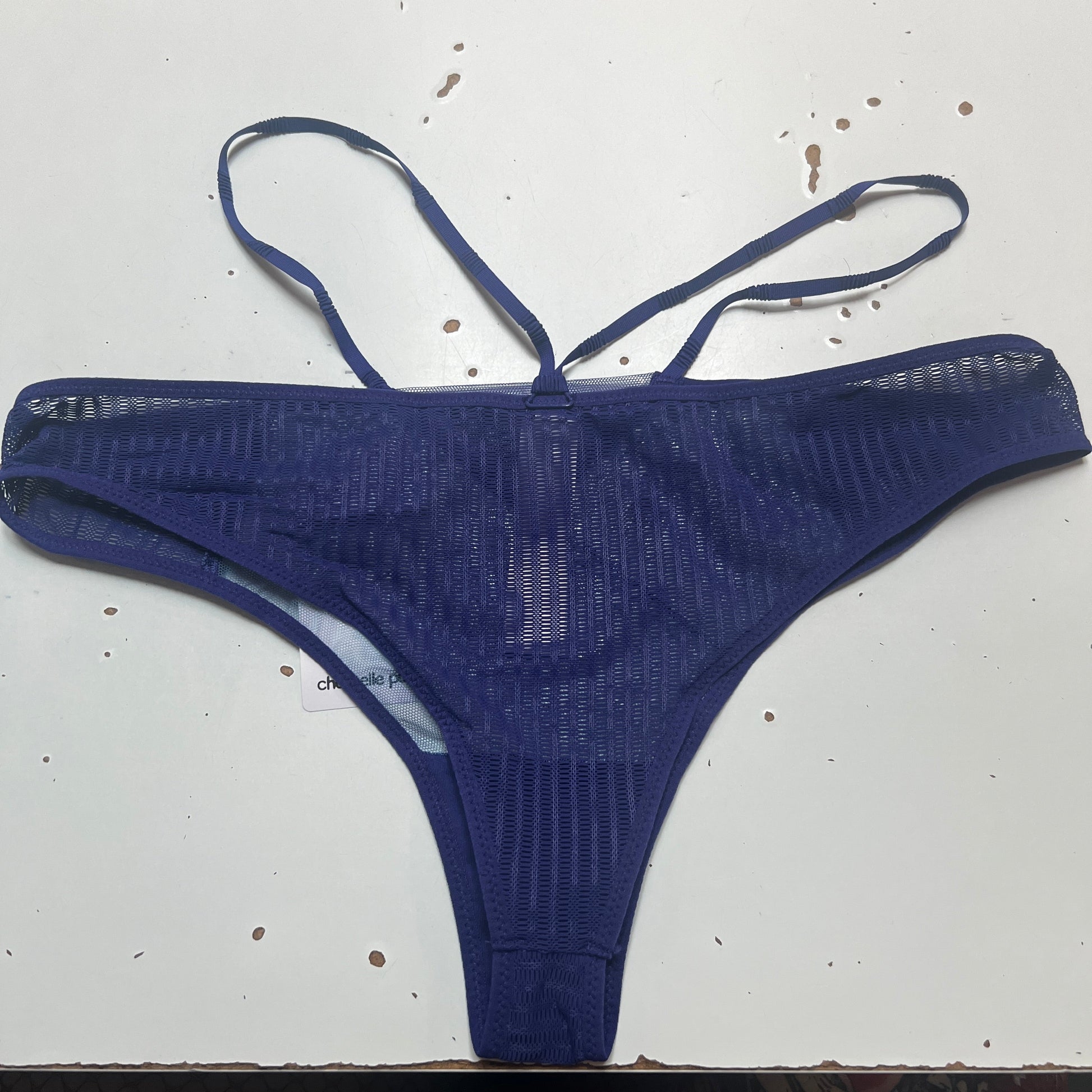 Blue thong on a white surface