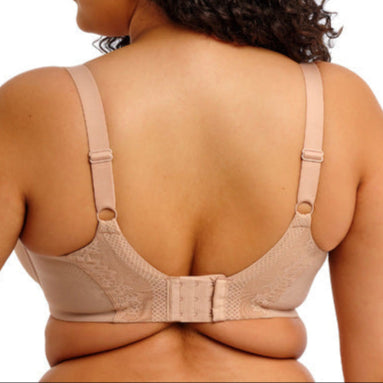 Woman wearing a beige compression garment on a white background