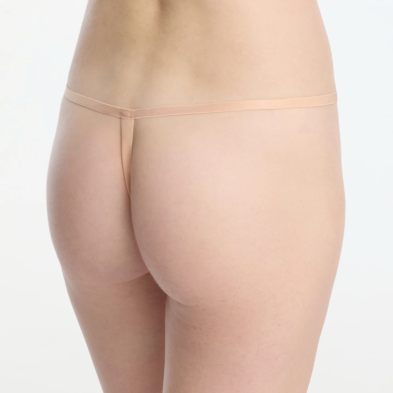 Beige sheer thong on a white background