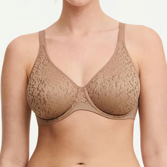 Woman wearing a beige bra on a plain background