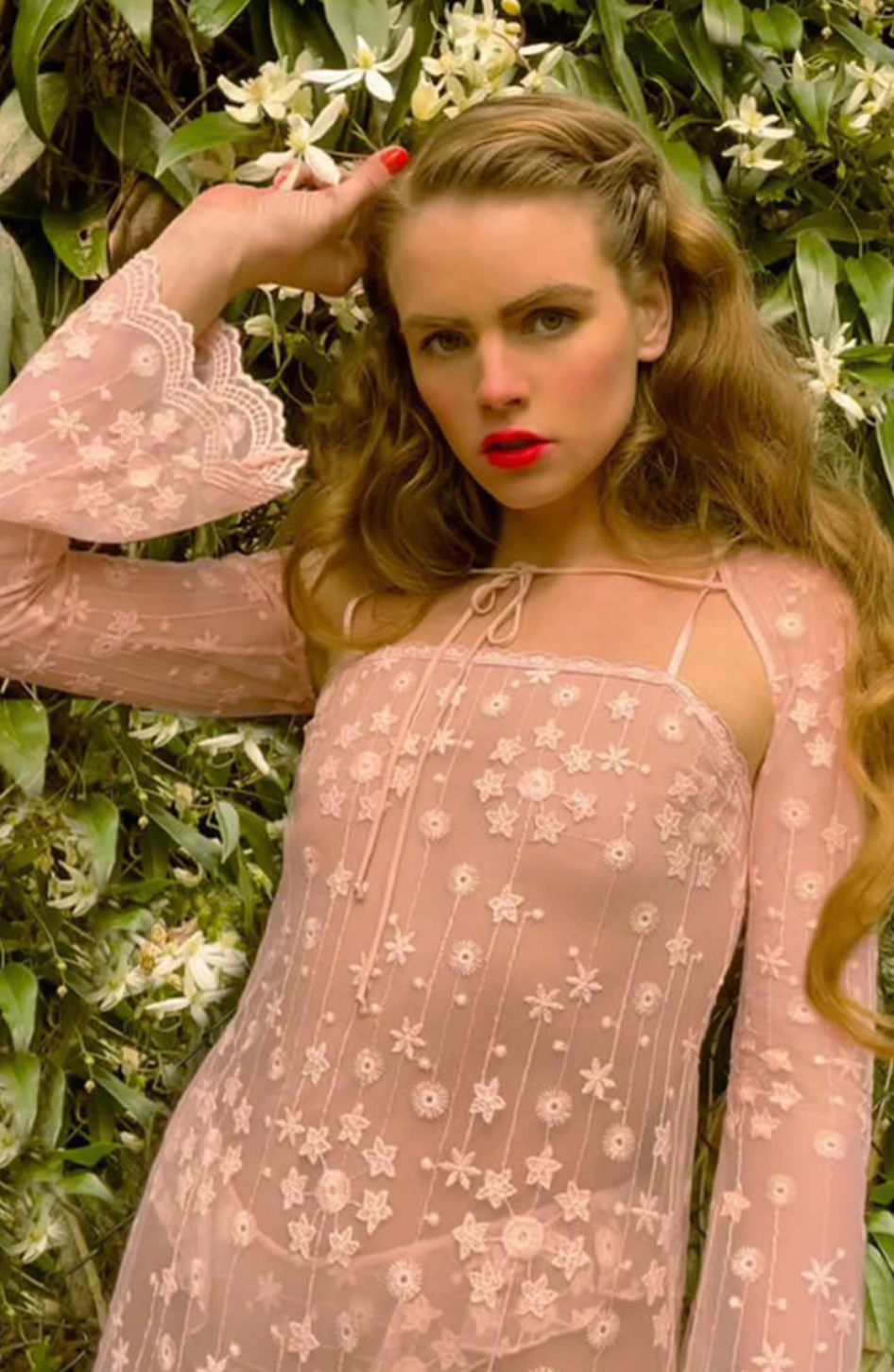 Model wearing Only Hearts Lucky Star petal pink heart mesh bolero with sheer long sleeves