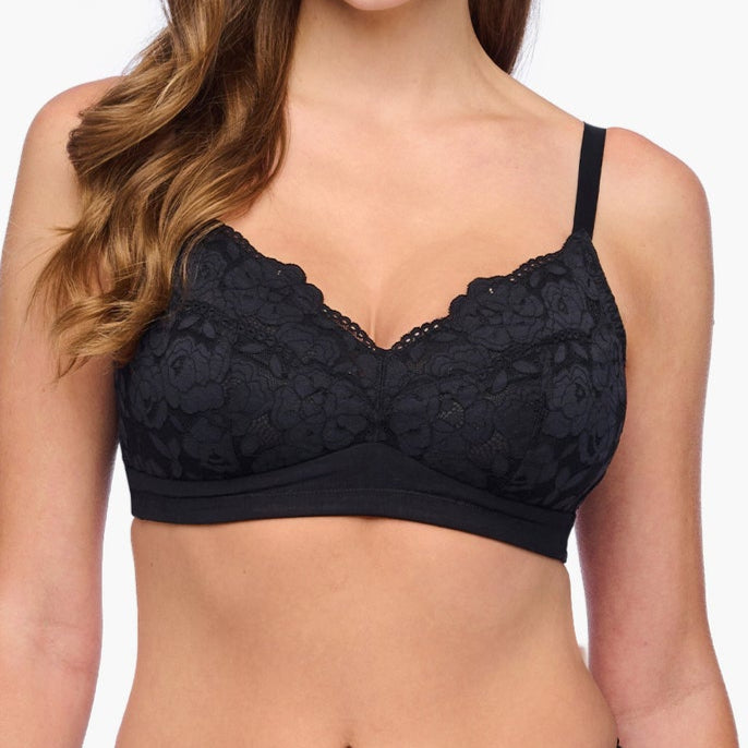 Woman wearing a black lace lingerie set on a white background