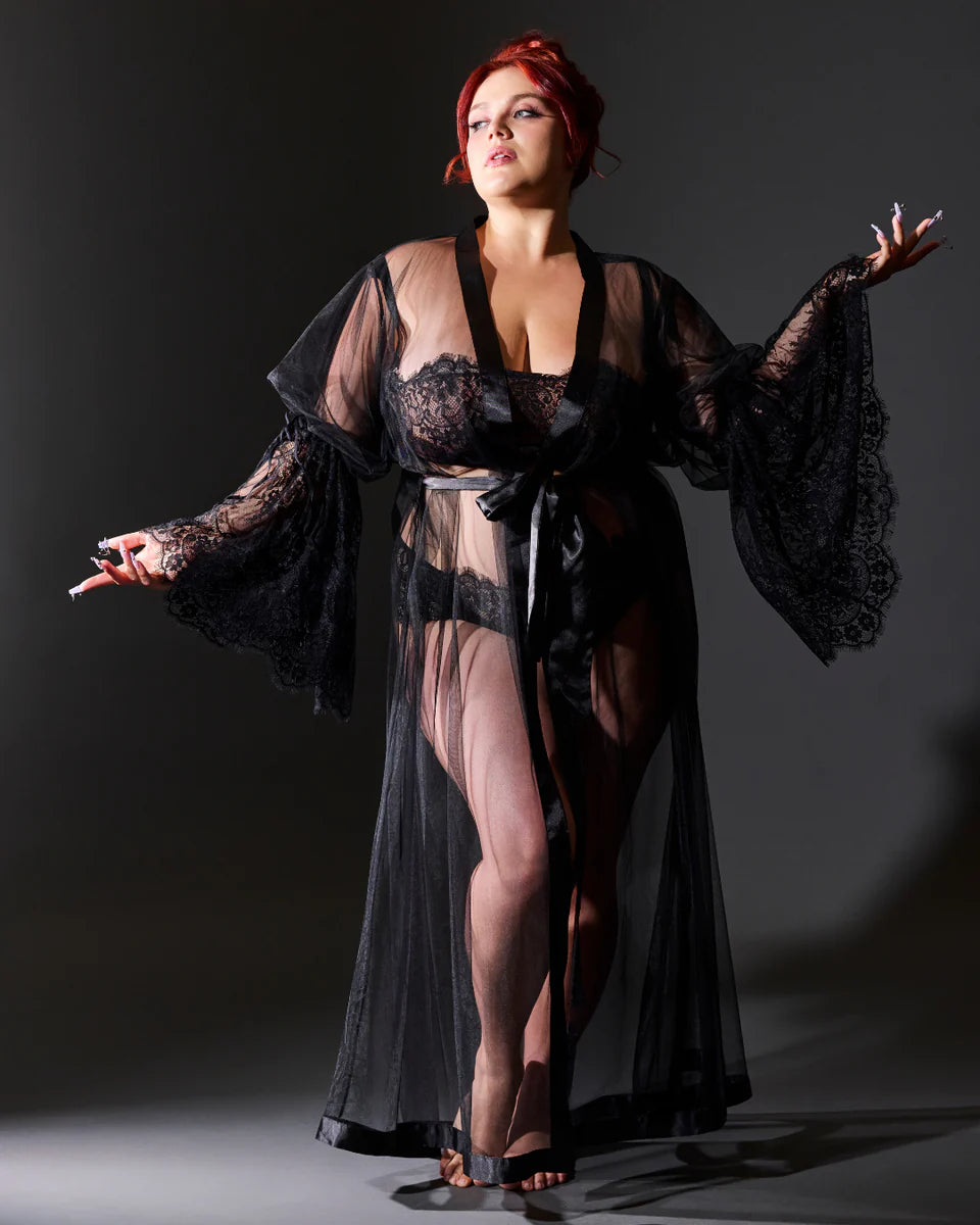 Plus-size model wearing a sheer black lace lingerie robe